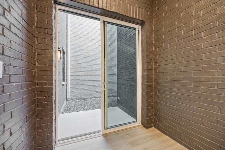 Exterior details and patio area of a home in Newman Village Townhomes, Frisco (Image 4).
