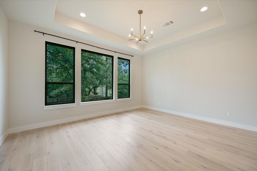 Bright windows frame lush greenery in this inviting, spacious living area.