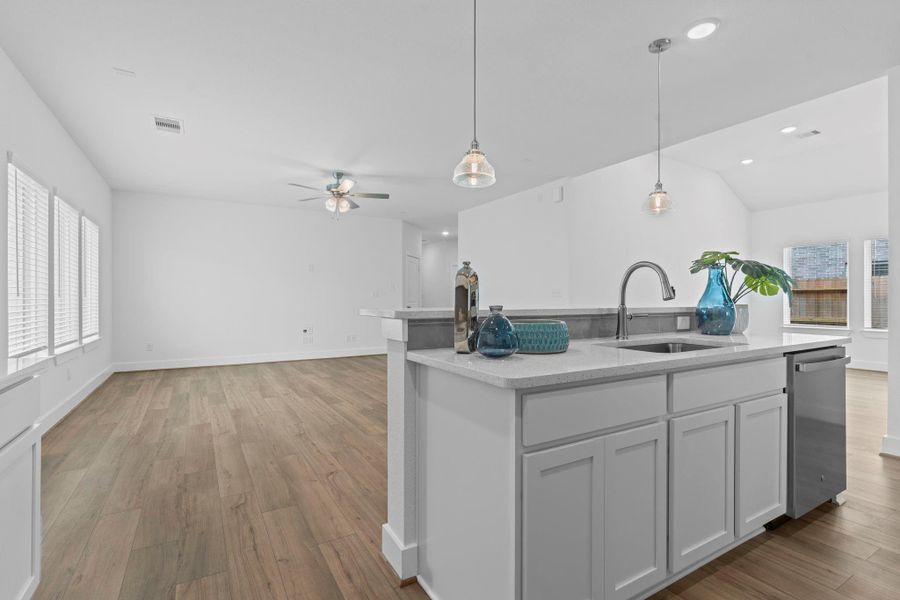 Bright and airy main living space connects effortlessly to the kitchen and dining areas, with pendant lighting and wide windows creating a warm, inviting atmosphere. **Image Representative of Plan Only and May Vary as Built**.