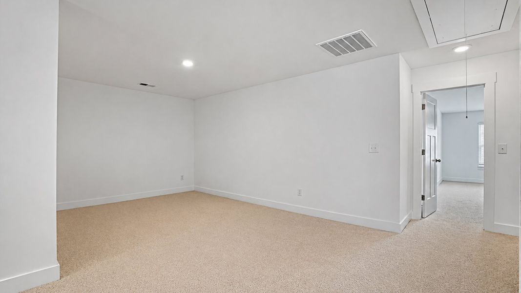 Refined loft with comfortable carpeted flooring and tasteful design throughout at the Village at Midway community Refined loft with comfortable carpeted flooring and tasteful design throughout at the Village at Midway community