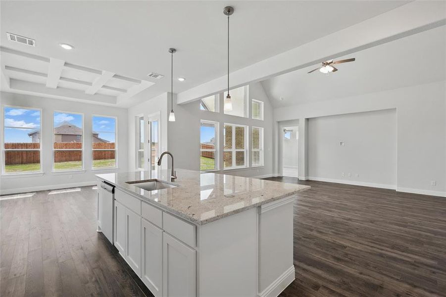 Kitchen featuring open floor plan, baseboards, a sink, dark wood-style floors, and visible vents
