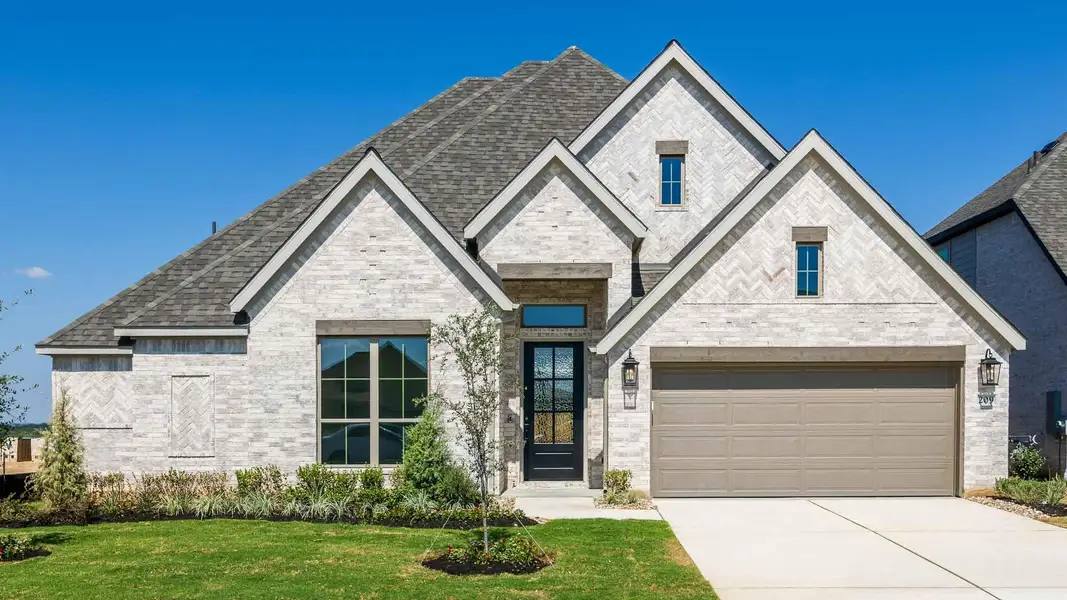 French country home with brick siding, driveway, a front lawn, a garage, and a shingled roof