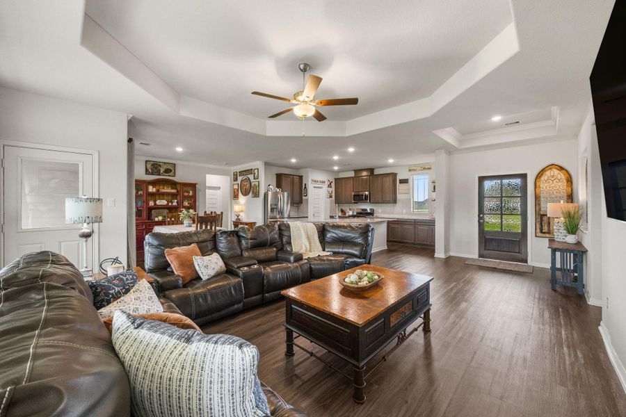 Island kitchen with bar seating and granite countertops.