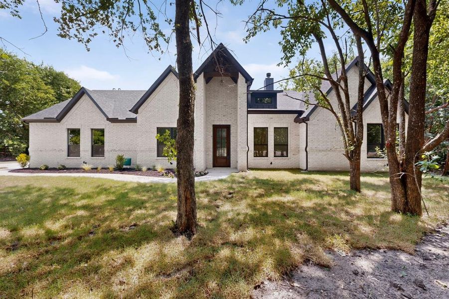Contemporary-style residence featuring a light-colored brick exterior
