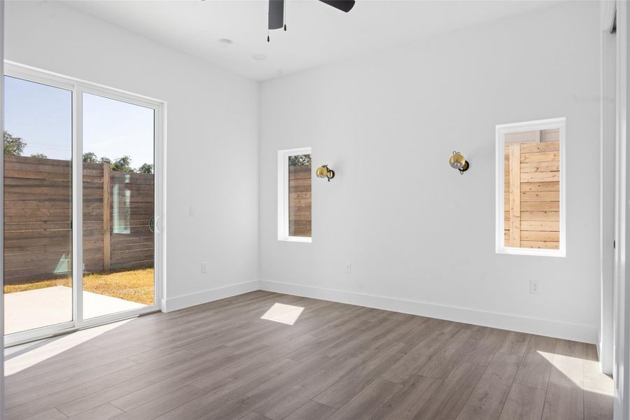 Empty room featuring wood finished floors and ceiling fan Empty room featuring wood finished floors and ceiling fan