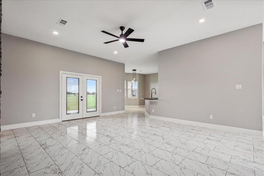 Unfurnished room with french doors, a ceiling fan, marble finish floor, baseboards, and visible vents