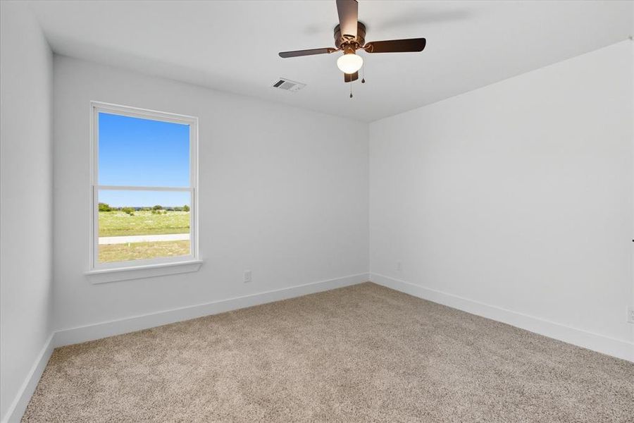 Unfurnished bedroom with light carpet and ceiling fan