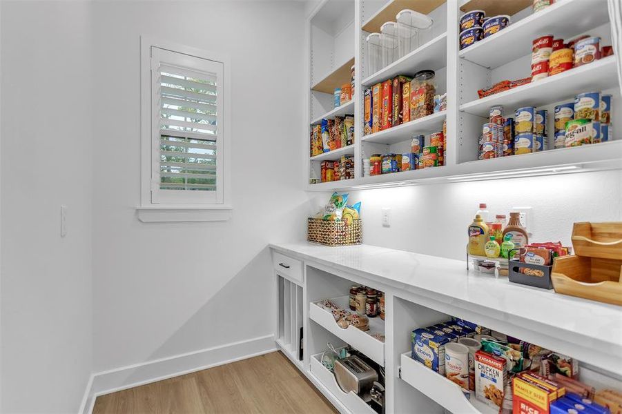 Well appointed walk-in pantry with appliance bar and custom storage solutions. Well appointed walk-in pantry with appliance bar and custom storage solutions.