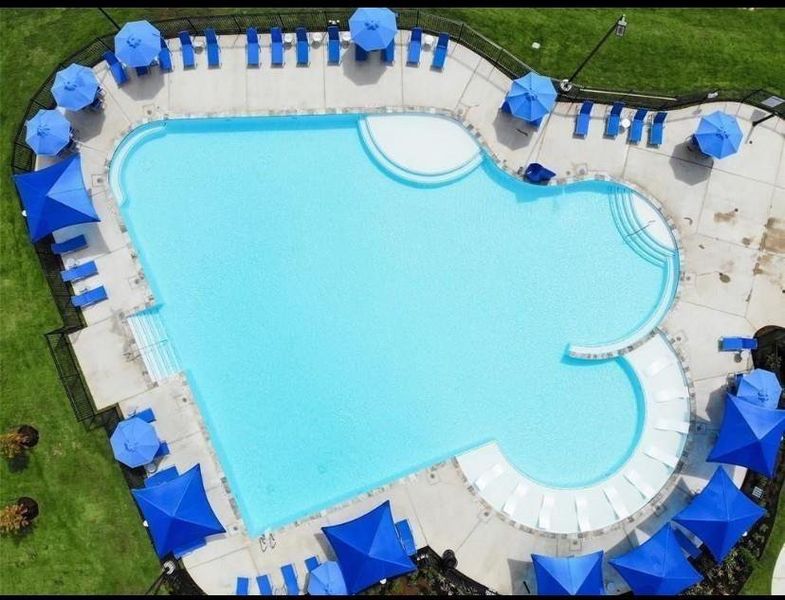 Comfortable lounge chairs line the water’s edge, with private cabanas offering shade and serenity.