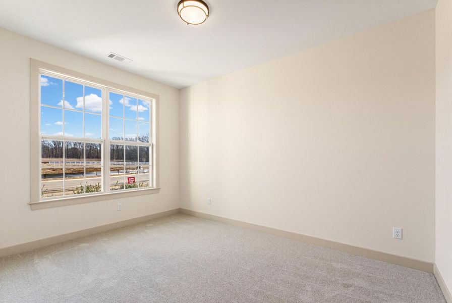 Unfurnished room with light carpet and baseboards