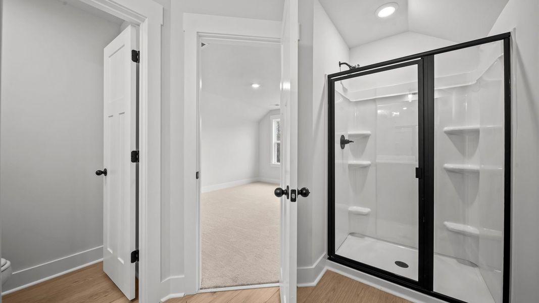 Accomplished full bath with walk-in shower designed with both comfort and sophistication in mind