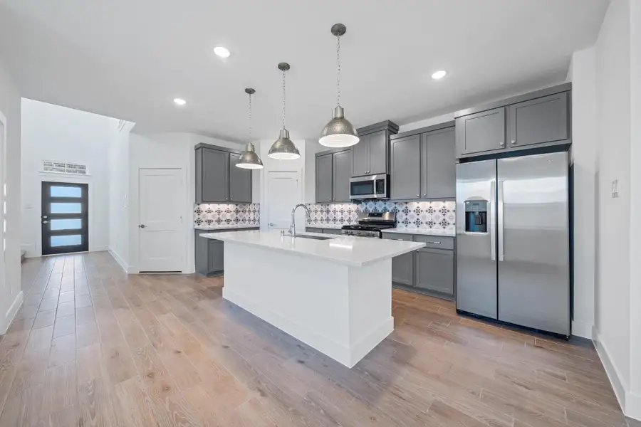 Representative furnished interior of a home built from the Sage by Chesmar Homes in Sunterra, Katy (Image 3).