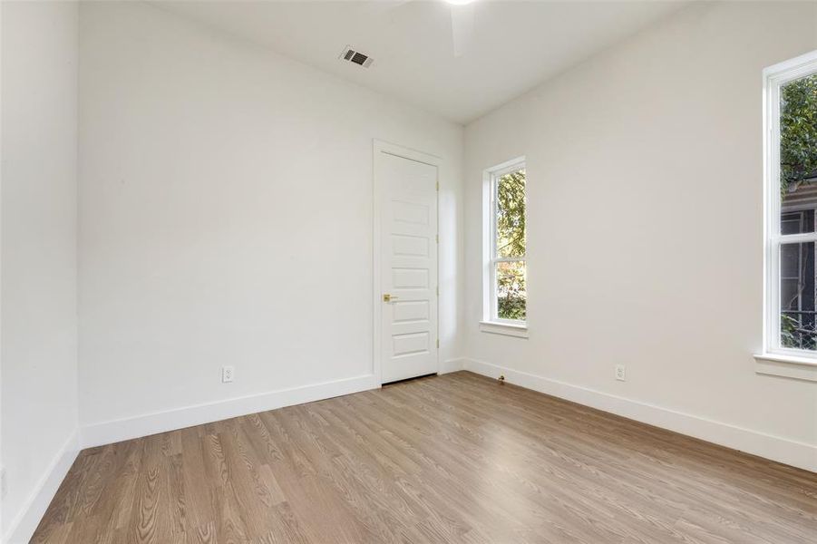 Spare room featuring wood finished floors and a ceiling fan Spare room featuring wood finished floors and a ceiling fan