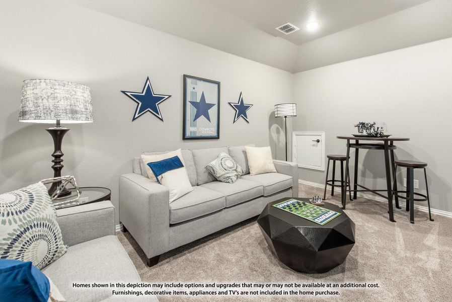 Bonus room with gray sofa, geometric coffee table, and sports-themed wall decor on carpet