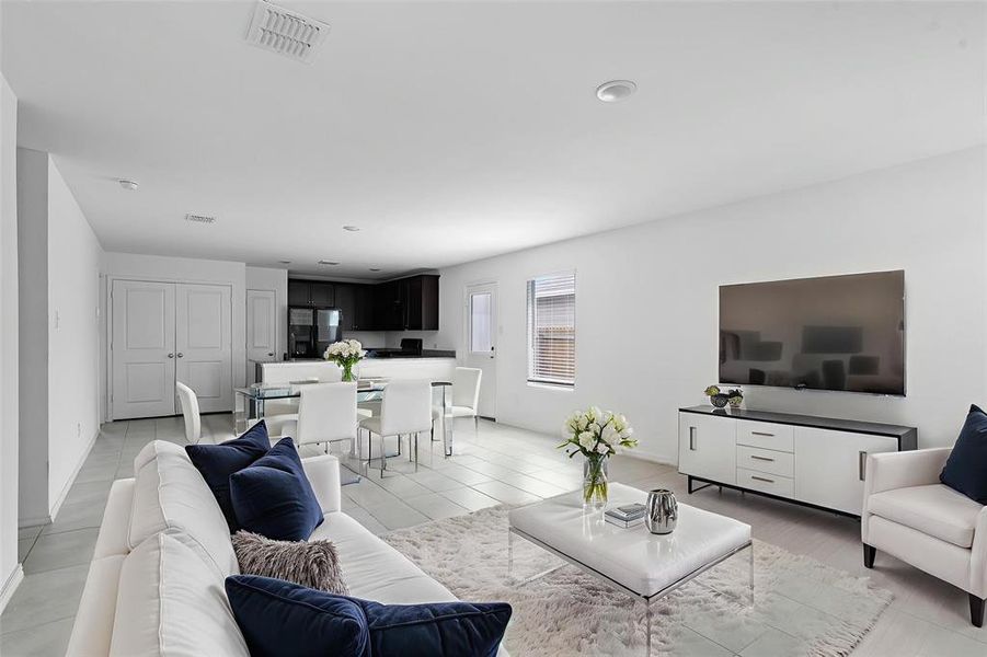 Living area with light tile patterned floors and baseboards