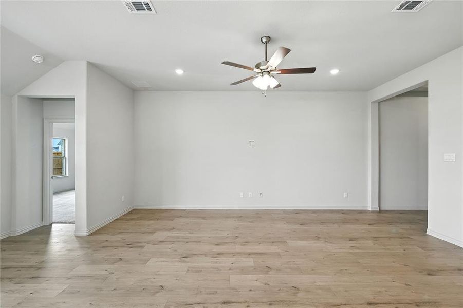 Empty room featuring light wood finished floors, recessed lighting, and a ceiling fan Empty room featuring light wood finished floors, recessed lighting, and a ceiling fan