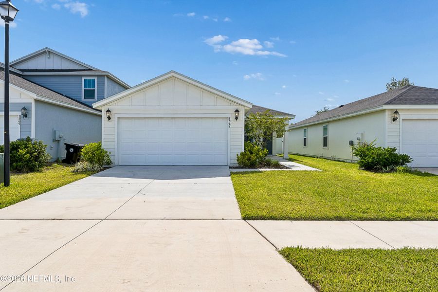 Front exterior of a new home in Lakes at Bella Lago – Classic Series, Green Cove Springs, FL, highlighting curb appeal (Image 18).