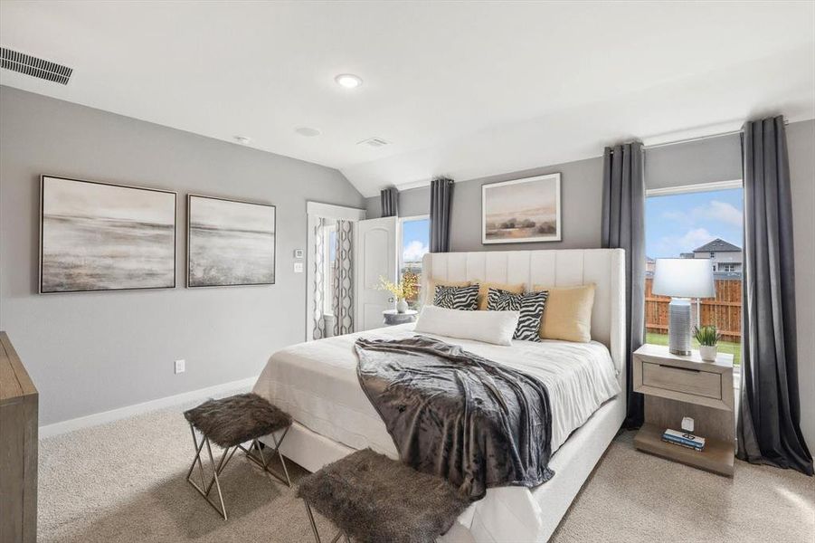 Bedroom featuring carpet and lofted ceiling