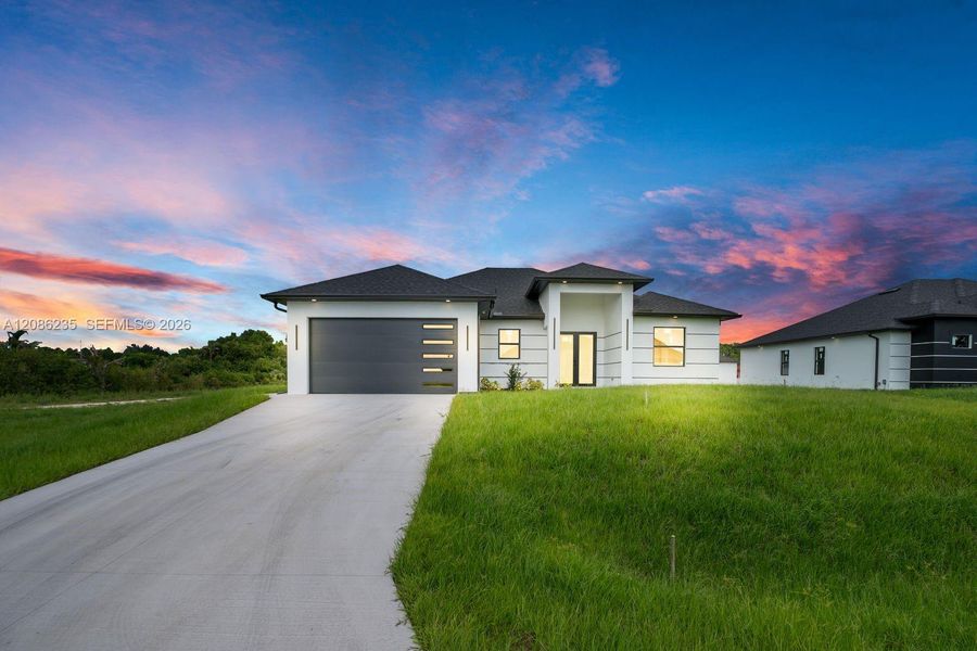 Front exterior of a new home in , Lehigh Acres, FL, highlighting curb appeal (Image 20).