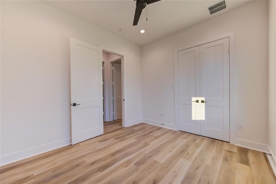 Guest Bedroom 1. Home comes with LED recessed lighting and ceiling fans pre-installed in all rooms.