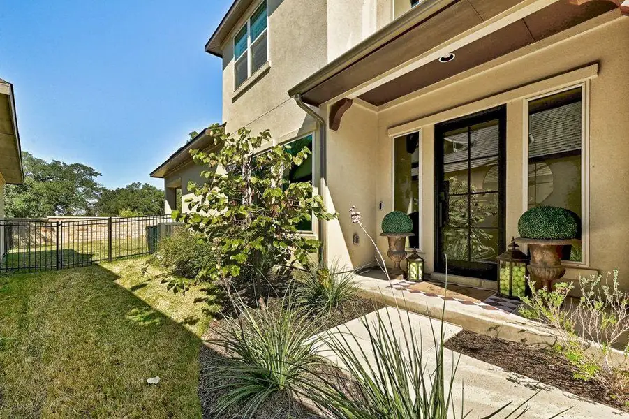 View of exterior entry with stucco siding and wood details View of exterior entry with stucco siding and wood details