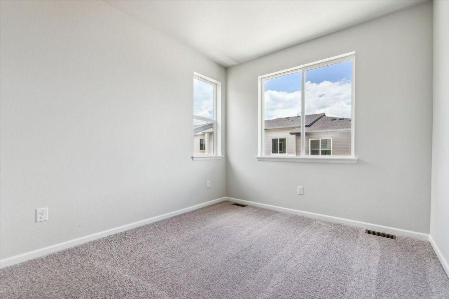 A room with a window and a carpet. A room with a window and a carpet.