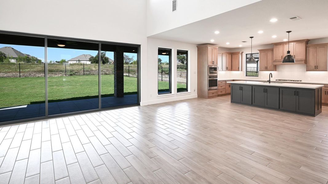 Kitchen with pendant lighting, backsplash, recessed lighting, a center island with sink, and light wood-type flooring Kitchen with pendant lighting, backsplash, recessed lighting, a center island with sink, and light wood-type flooring