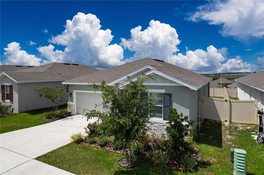 Front exterior of a new home in Seasons at Mabel Place, Lake Wales, FL, highlighting curb appeal (Image 29).