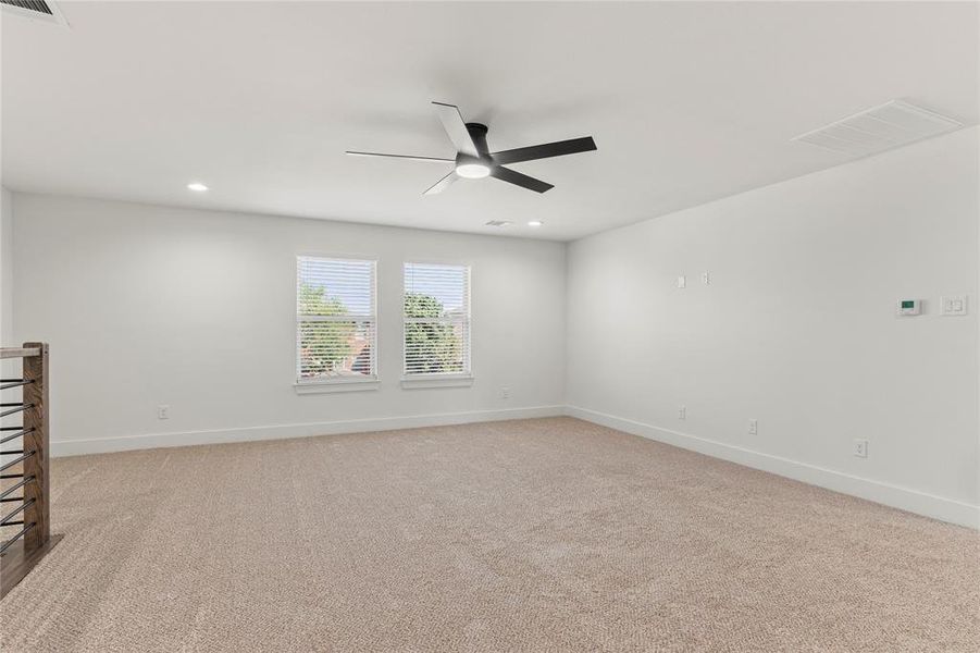 Spare room featuring light colored carpet, recessed lighting, and a ceiling fan Spare room featuring light colored carpet, recessed lighting, and a ceiling fan