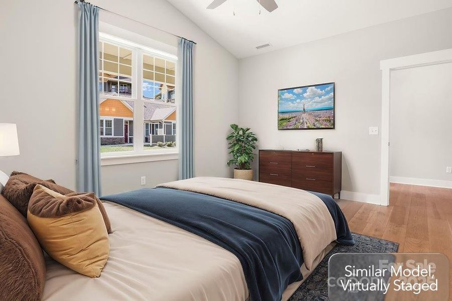 Secondary bedroom with vaulted ceilings and ceiling fan Secondary bedroom with vaulted ceilings and ceiling fan