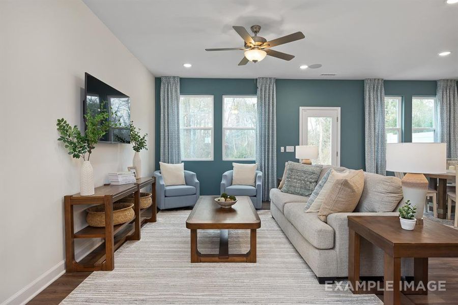 Living room featuring hardwood / wood-style floors, plenty of natural light, and ceiling fan