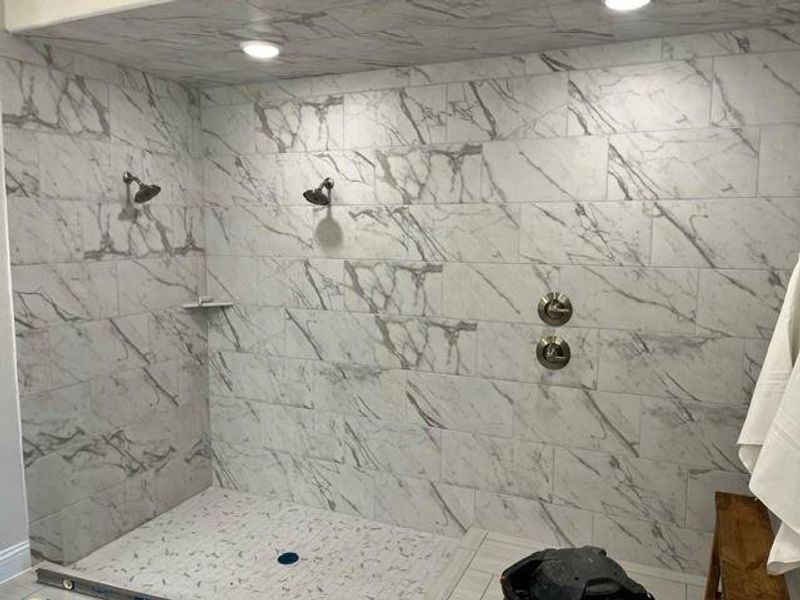 Bathroom featuring a tile shower Bathroom featuring a tile shower