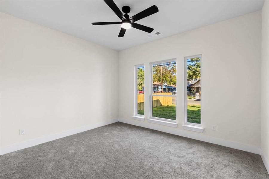 Empty room with carpet floors and ceiling fan