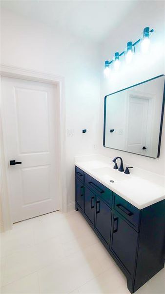 Bathroom featuring tile patterned floors and vanity