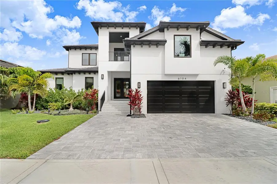 Front exterior of a new home in , Apollo Beach, FL, highlighting curb appeal (Image 1). Front exterior of a new home in , Apollo Beach, FL, highlighting curb appeal (Image 1).