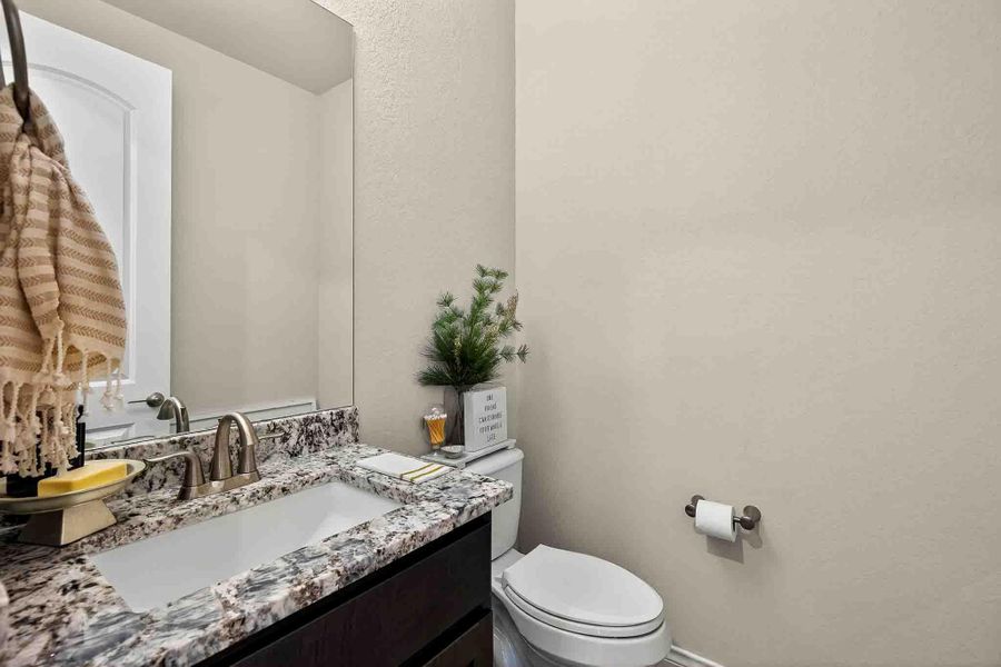 Bathroom featuring vanity and a textured wall