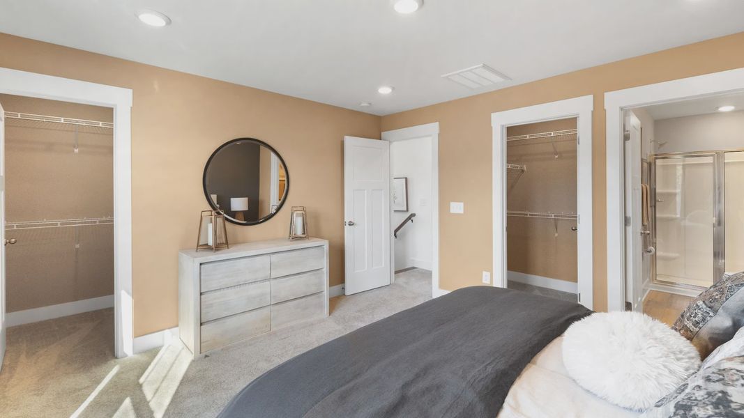 Vibrant natural light fills this exceptional primary suite of The Churchill Design with eye-catching details