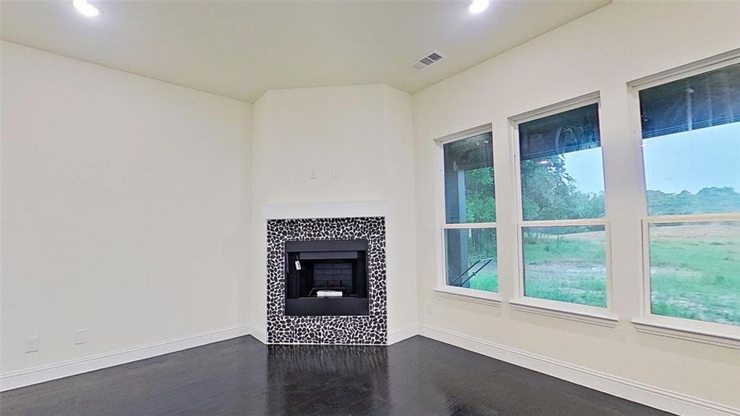 Unfurnished living room with a fireplace, dark wood-style floors, and recessed lighting Unfurnished living room with a fireplace, dark wood-style floors, and recessed lighting