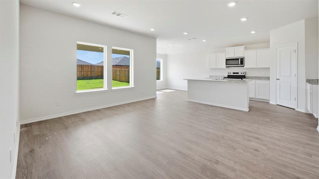 Unfurnished living room featuring light wood-type flooring and recessed lighting