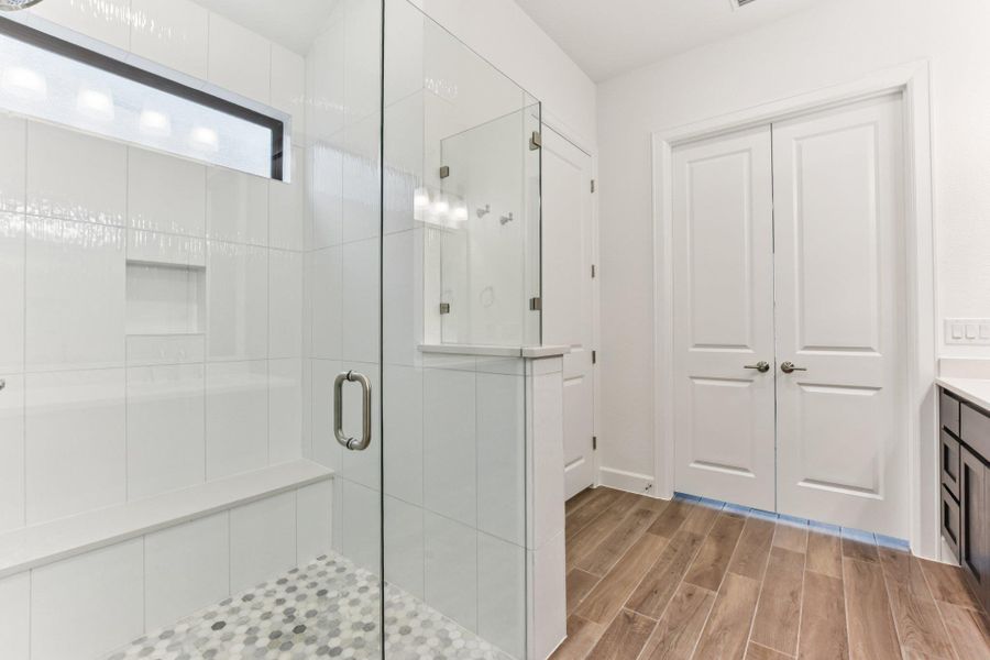 Bathroom with vanity, wood finish floors, and a shower stall Bathroom with vanity, wood finish floors, and a shower stall