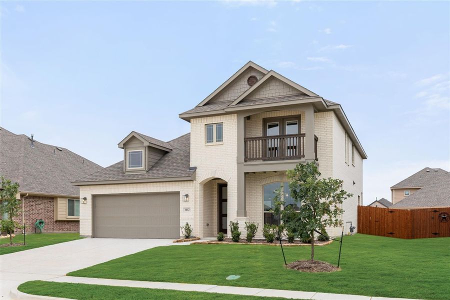 Two-story brick home with second-floor balcony, two-car garage, and manicured front lawn Two-story brick home with second-floor balcony, two-car garage, and manicured front lawn