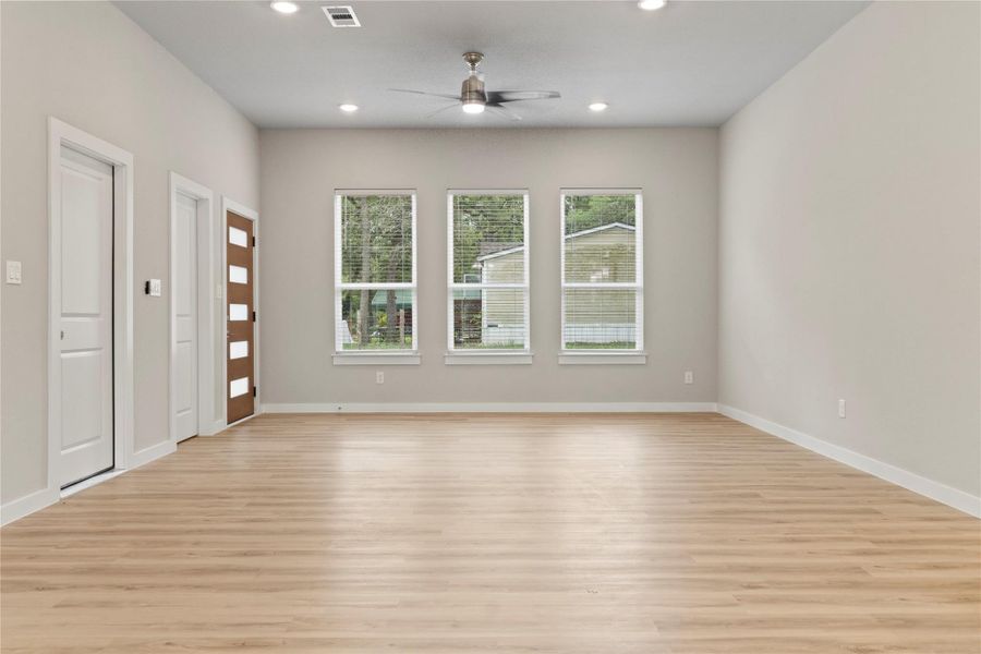 An inviting open floor plan, seamlessly connecting the living and dining areas, bathed in natural light—shown from a different angle. An inviting open floor plan, seamlessly connecting the living and dining areas, bathed in natural light—shown from a different angle.