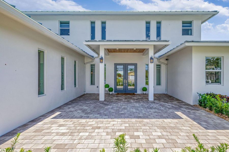 Front exterior of a new home in , North Palm Beach, FL, highlighting curb appeal (Image 26). Front exterior of a new home in , North Palm Beach, FL, highlighting curb appeal (Image 26).