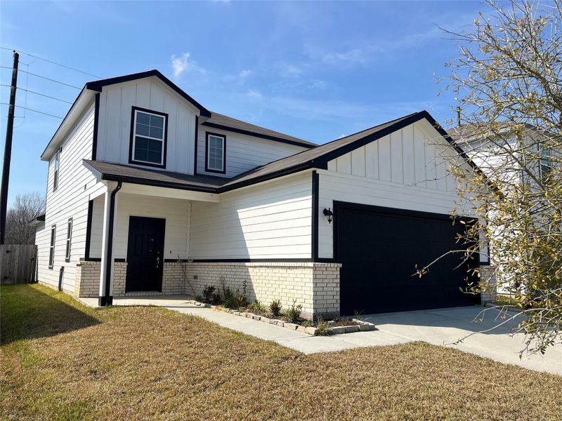 Front exterior of a new home in Barrett Crossing, Crosby, TX, highlighting curb appeal (Image 2). Front exterior of a new home in Barrett Crossing, Crosby, TX, highlighting curb appeal (Image 2).