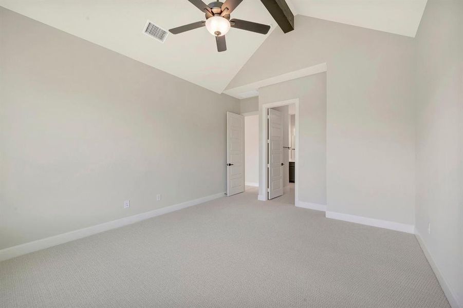 Vaulted ceiling with an exposed beam and a ceiling fan