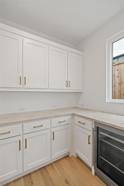 Tucked away off of the kitchen is the butlers pantry complete with beverage fridge and access to the food pantry.