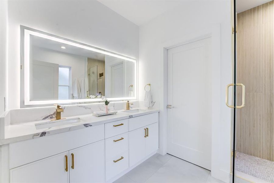 The spa-like primary ensuite bathroom has luxurious features such as the lighted mirror, frameless shower, garden soaking tub, and impressive walk-in closet.