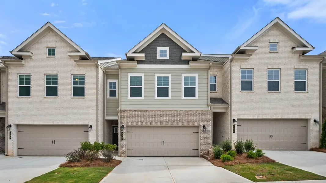 Front exterior of a new home in Abbotts Crossing Towns, Conyers, GA, highlighting curb appeal (Image 2). Front exterior of a new home in Abbotts Crossing Towns, Conyers, GA, highlighting curb appeal (Image 2).