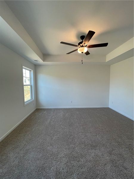 This airy room features a high ceiling, a window,