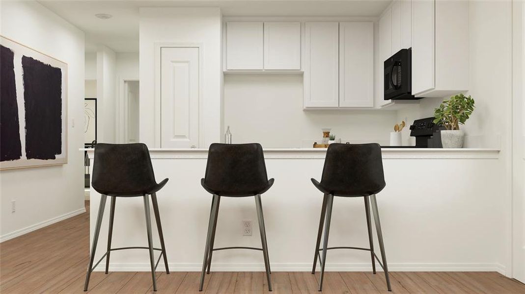 Kitchen featuring light hardwood / wood-style flooring and white cabinetry